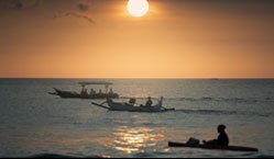 Balinese fishing boats coming to shore at sunset