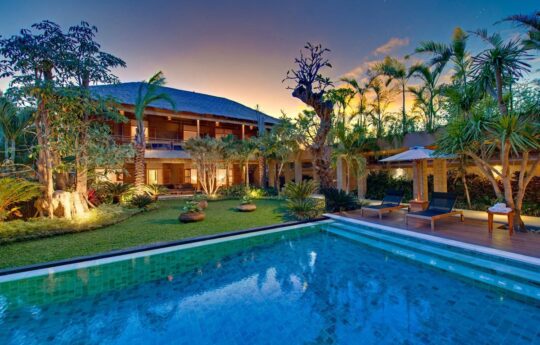 Villa Kinara at dusk with swimming pool outlook from living area and views of two storey villa