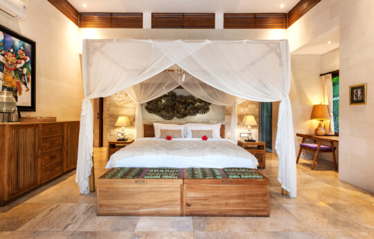 King size bed of villa with mosquito netting