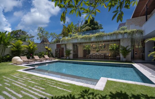 Villa exterior on sunny day with swimming pool views with garden