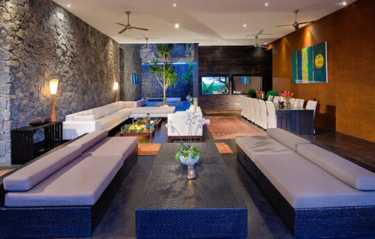 Modern living and dining areas of villa with sofas