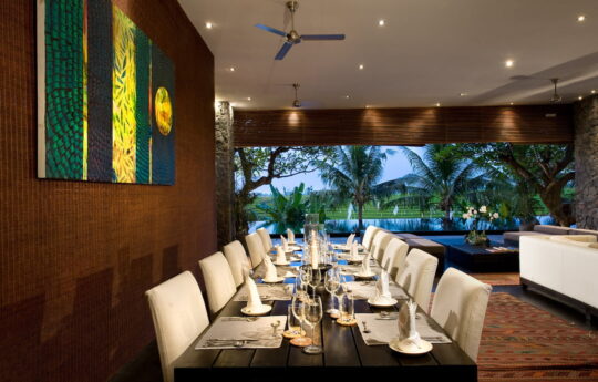 Dining table of villa with seating for 10 people with rice field views
