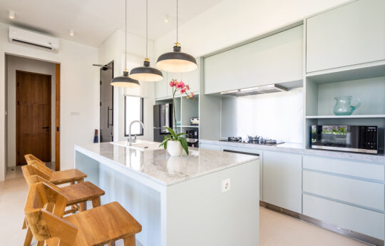 kitchen of villa with island bench and 3 stools