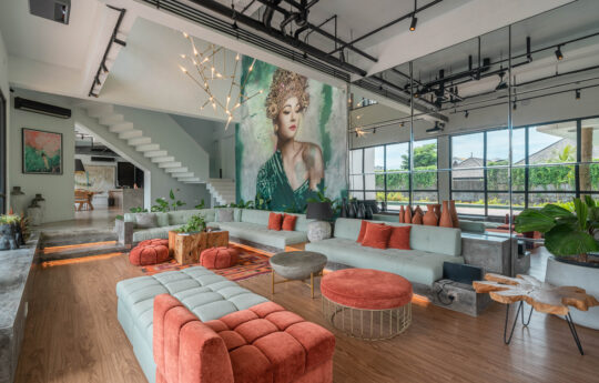 Living areas of villa with large l shaped sofa and wall art