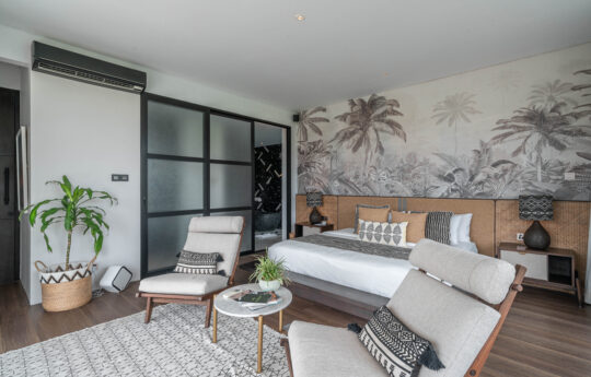 Bedroom with king sized bed and two chairs