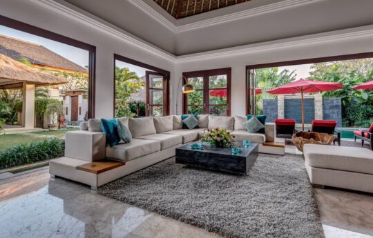 Lounge area of villa with l shaped sofa and rug