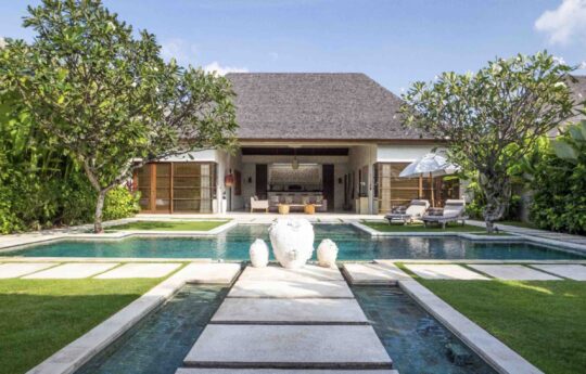 swimming pool and garden area of villa with building exterior of villa in background