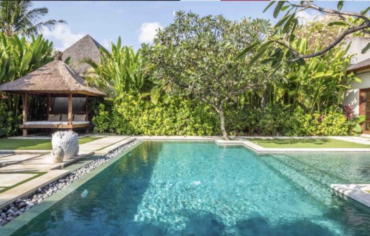gazebo of villa in background with garden area are topical garden