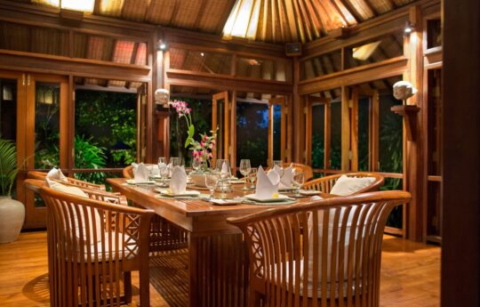 Dining area of villa with table set for 8 people