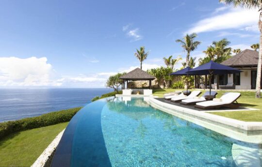 swimming pool and villa exterior at top of cliff