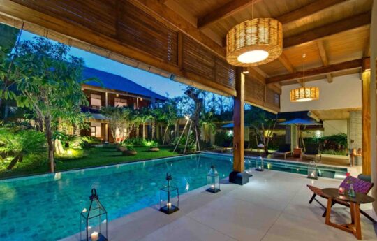 Villa Kinara at dusk with swimming pool outlook from living area and views of two storey villa