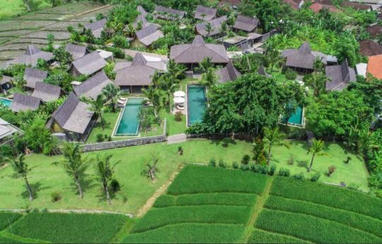Aerial view of large villa estate in bali with rice filed views