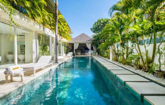 Full length of villa with swimming pool views and cabana at end of pool