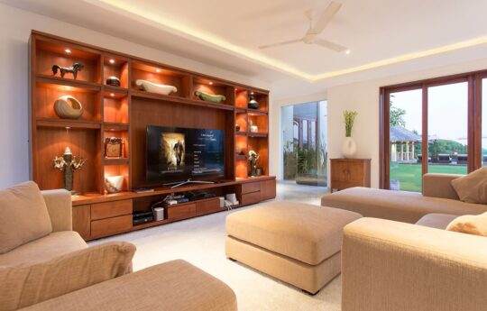 lounge room of villa with flat screen TV and plush sofa