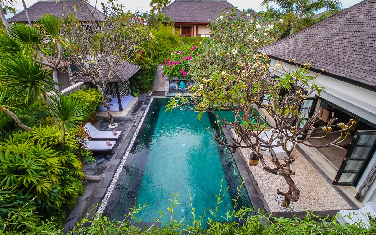 Aerial view of villa with swimming pool and day beds