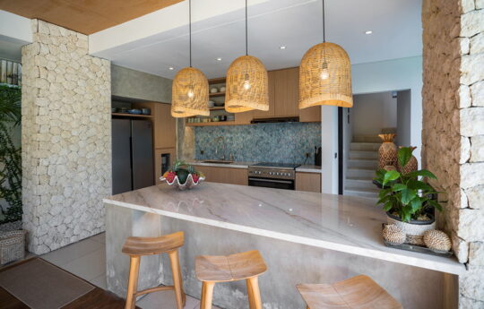 Modern kitchen of villa with three stolos at breakfast bar