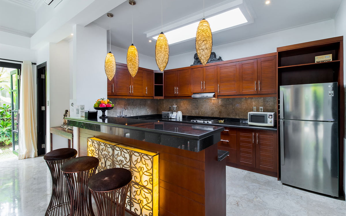 Modern kitchen at villa with three bar stools at island bench