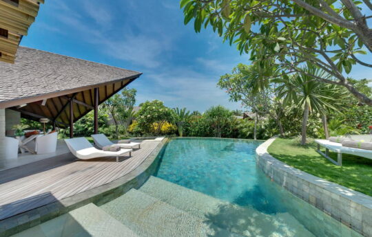 Swimming pool and villa exterior on sunny day in Seminyak, bali
