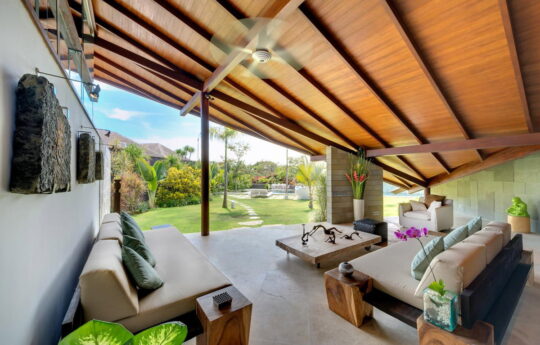 Lounge area of villa with couch and garden views