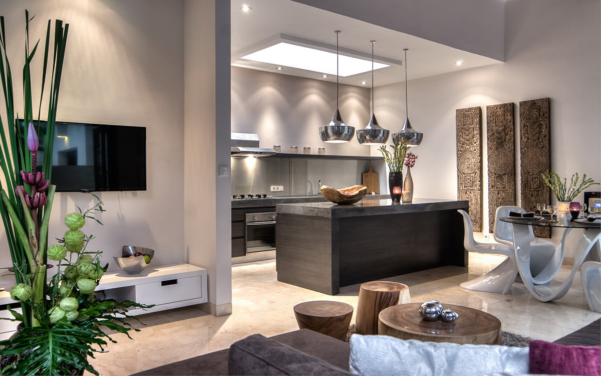 Comfy sofa of living room area with kitchen in background