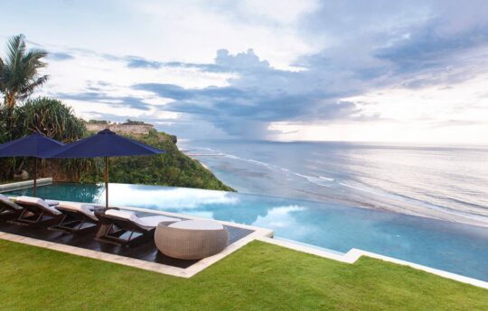 swimming pool and garden area of villa with views to ocean