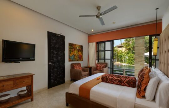 Modern bedroom with flatscreen TV and views to garden