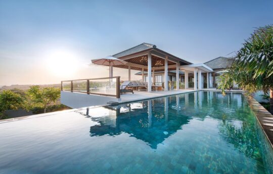 Swimming pool and villa exterior views during the day