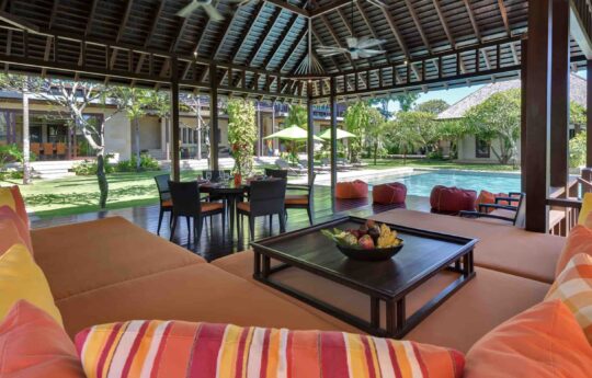 open plan lounge area in villa with views to swimming pool