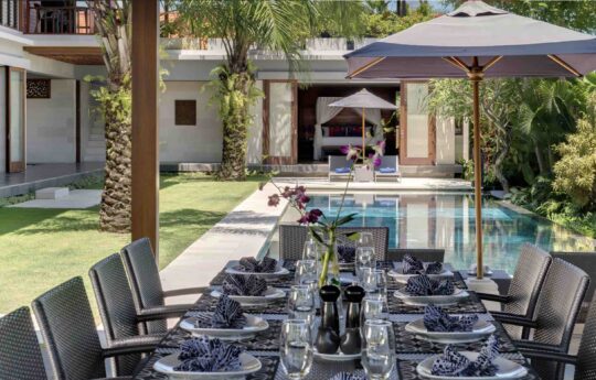 dining table of canggu villa bendega rato with pool and garden views