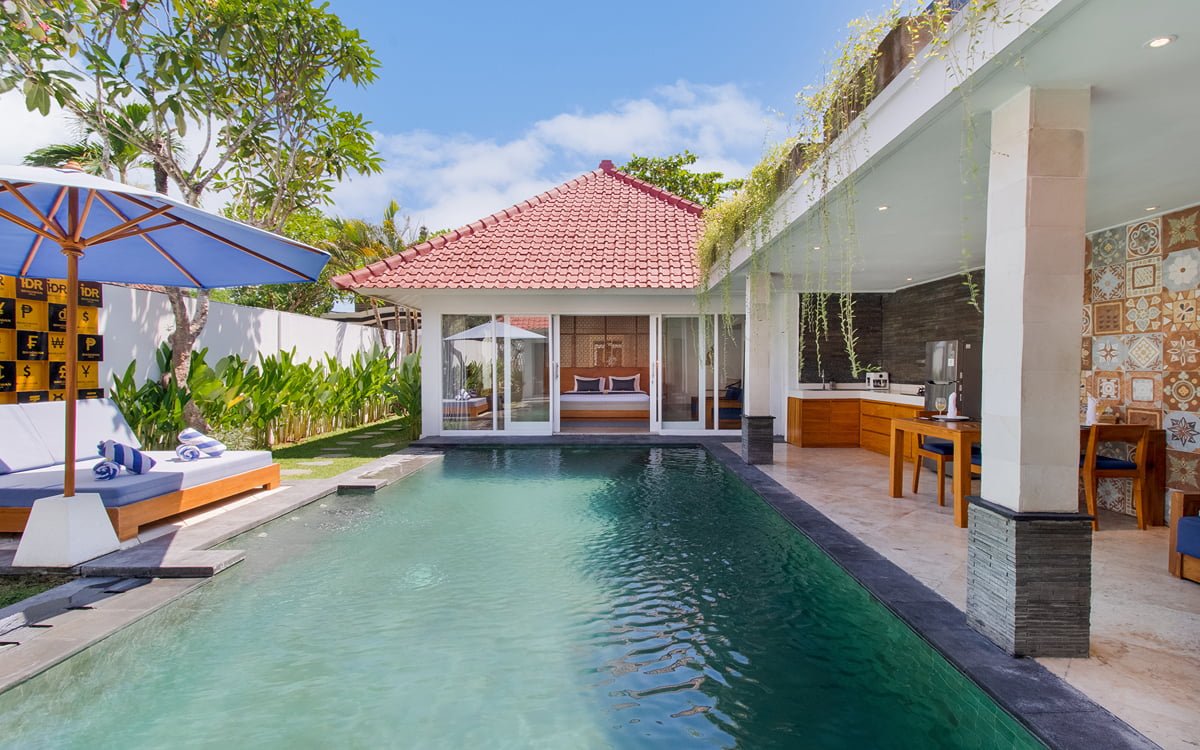 Swimming pool views on sunny day with villa exteriors in background