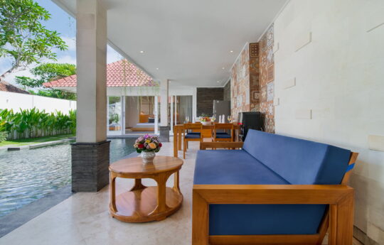 Sofa and coffee table with swimming pool in background