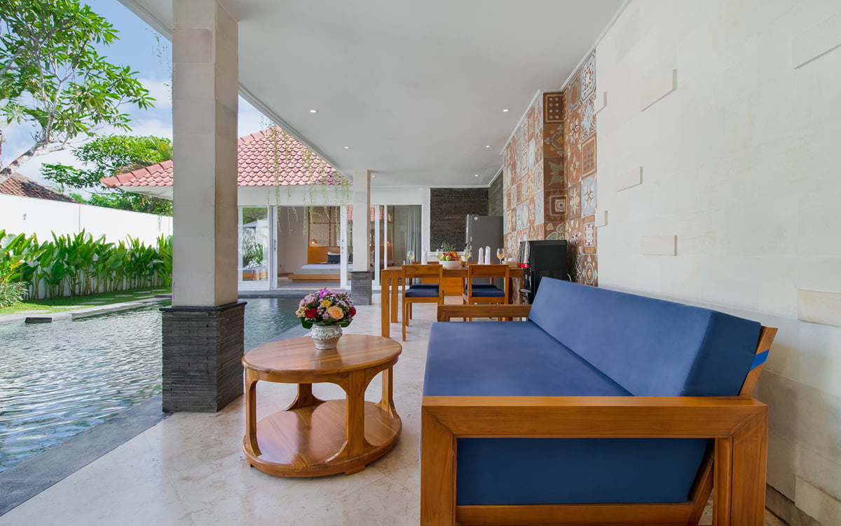 Sofa and coffee table with swimming pool in background