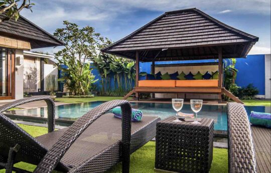 Villa Bon Bon Day beds by the pool with 2 champagne glasses and view of pool of Villa Bon Bon