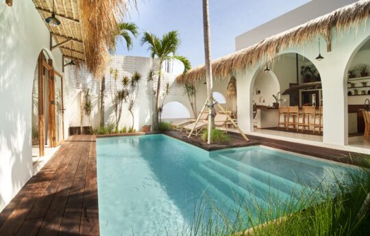 swimming pool and views of kitchen and living areas of villa during day