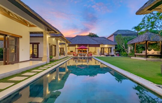 Villa Darma Swimming pool and exteriors at dusk with garden and gazebo