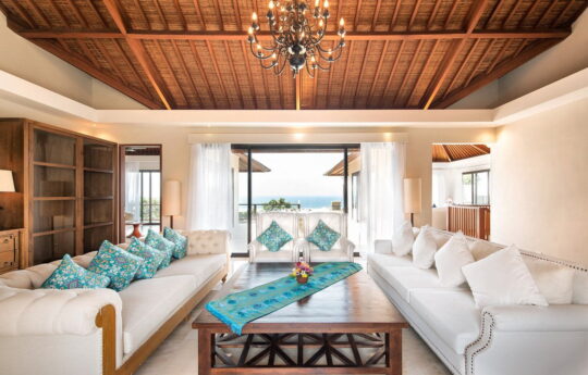 Lounge area of villa with two plush sofas and wooden coffee table