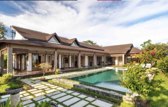 Exterior of villa with swimming pool and garden area