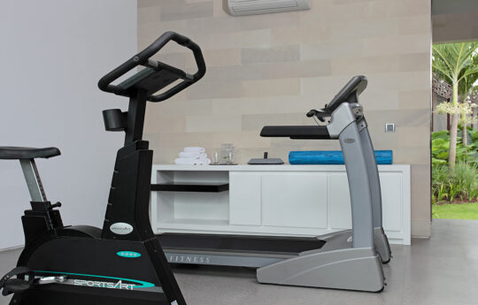 Gym inside villa with bicycle machine