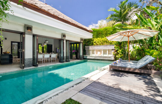 Villa Jepun Sunbeds by the pool during daytime with Villa Jepun's interiors in background