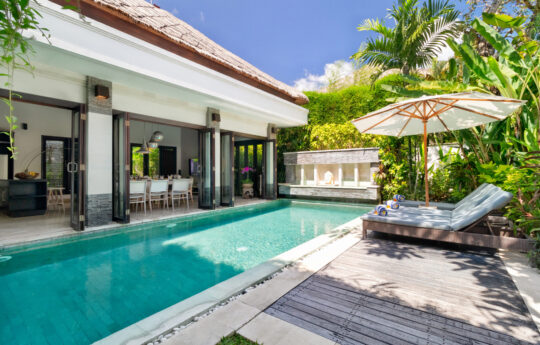 Villa Jepun Sunbeds by the pool during daytime with Villa Jepun's interiors in background