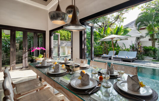 Villa Jepun Dining table with plates with views to pool area
