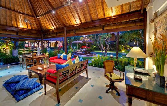 Living and dining area of Bali style villa with view of garden area