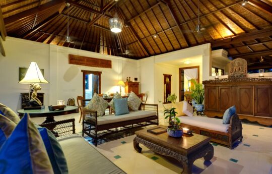 Internal living room of villa with lounge and bali style architecture