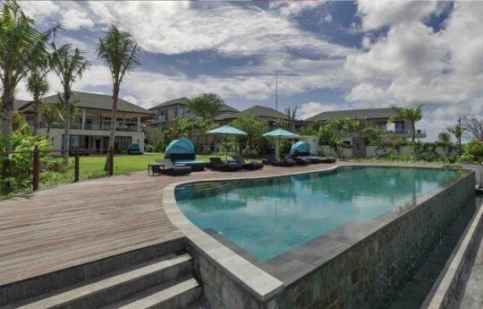 swimming pool and eck area of villa with exterior views and day beds