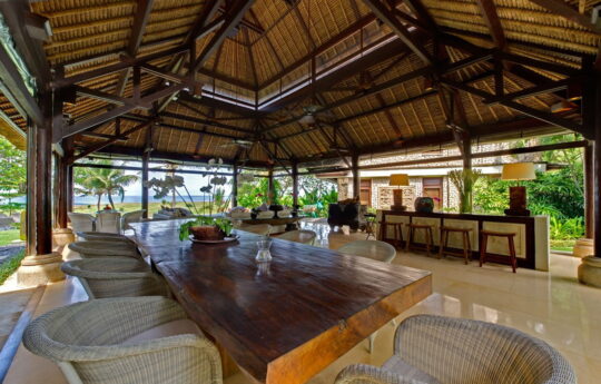 Open plan living area of villa with garden views