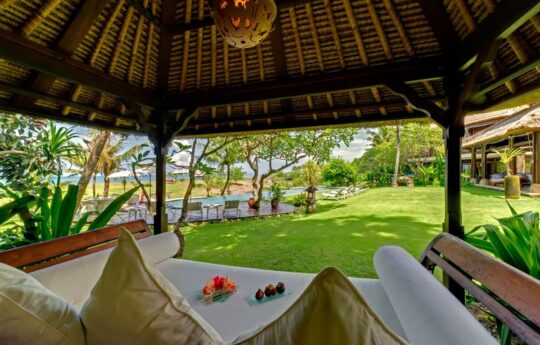 Garden views from outdoor gazebo area with palm trees