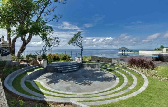 garden area of villa with ocean views and palm trees