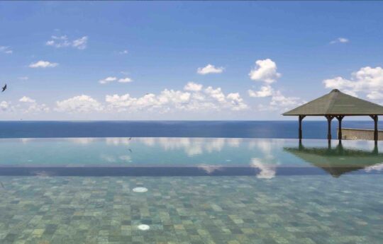 Infinity swimming pool of villa with ocean views and gazebo