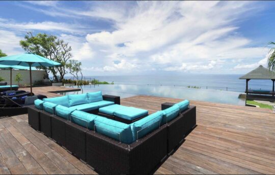 Sofa and lounge by the pool with ocean views