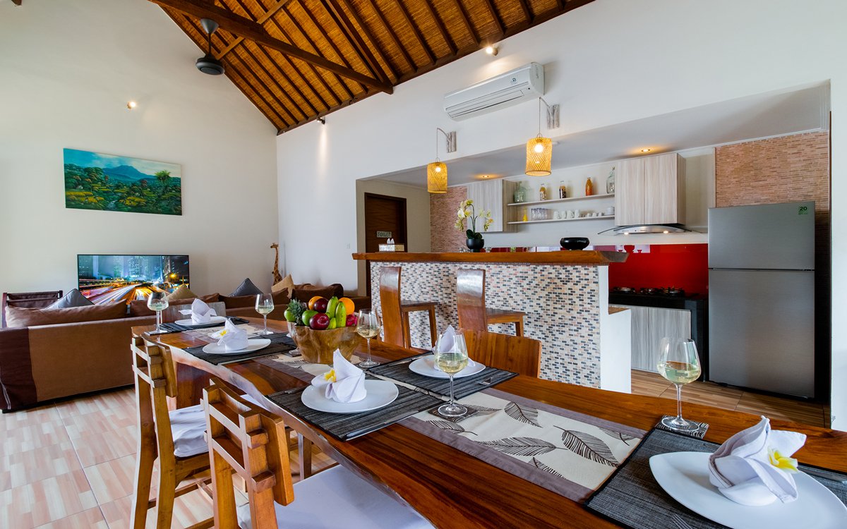 Dining table with kitchen in background and living area